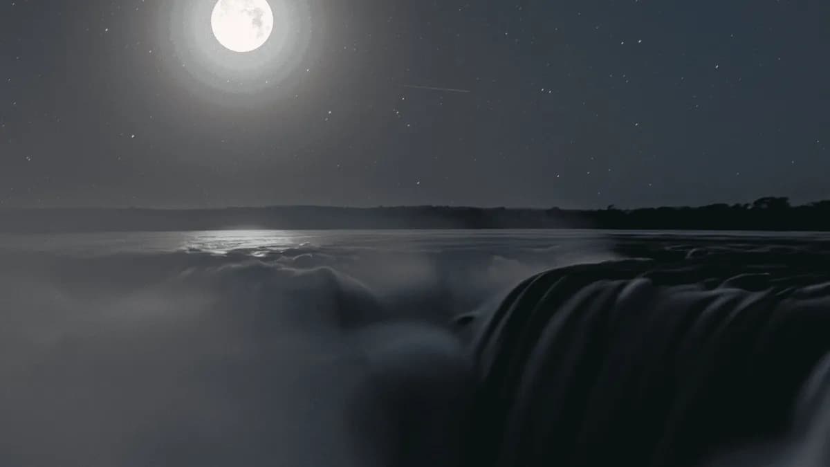 Iguazu Falls illuminated by the full moon during the nighttime walk